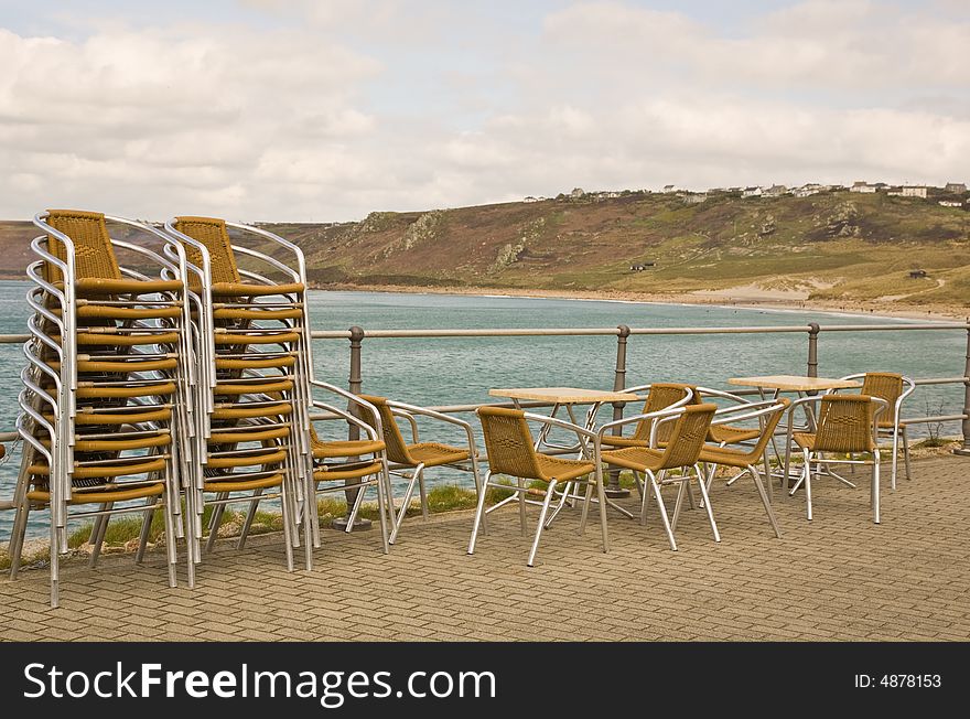 A set of stacked picnic chairs by the beach. A set of stacked picnic chairs by the beach