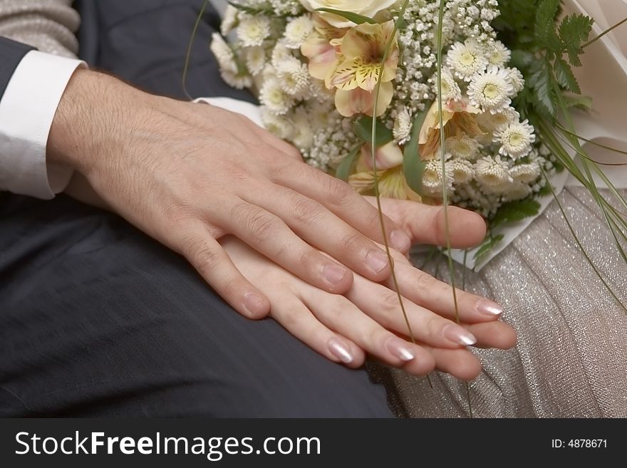 Newly-married couple with wedding bouquet