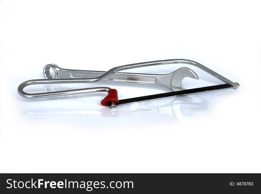 Saw and a wrench isolated on a white background