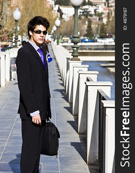 Businessman posing over urban background. Businessman posing over urban background