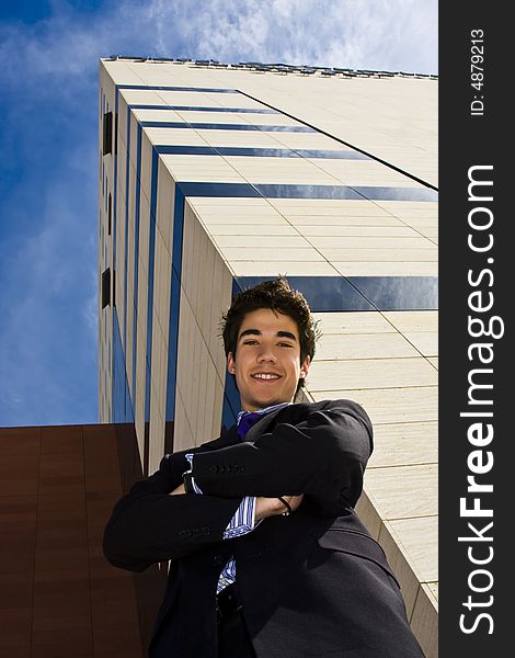 Young businessman portrait against urban background