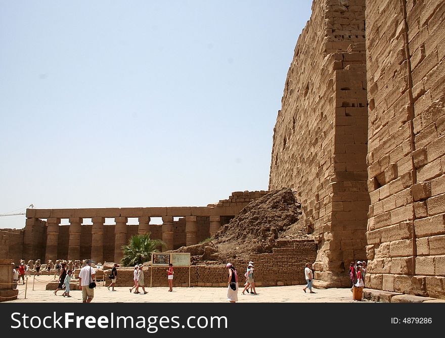 Ancient Luxor ruins, Egypt which are examined by tourists in hot day. Ancient Luxor ruins, Egypt which are examined by tourists in hot day