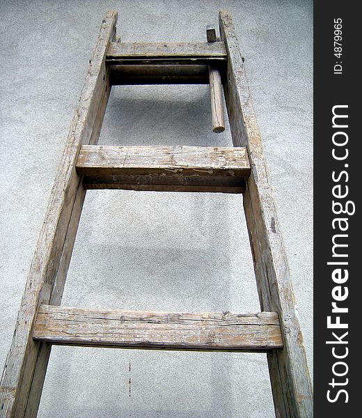 Old ladder on the wall - construction tool