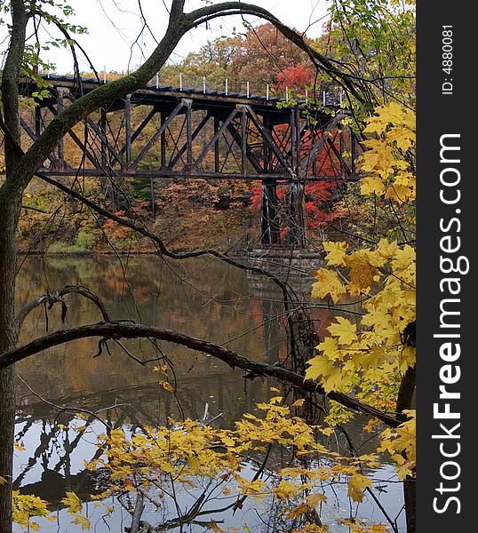 An old train bridge crossing a river. An old train bridge crossing a river