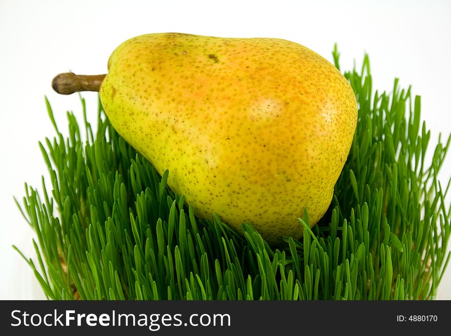 Pear on grass isolated on white