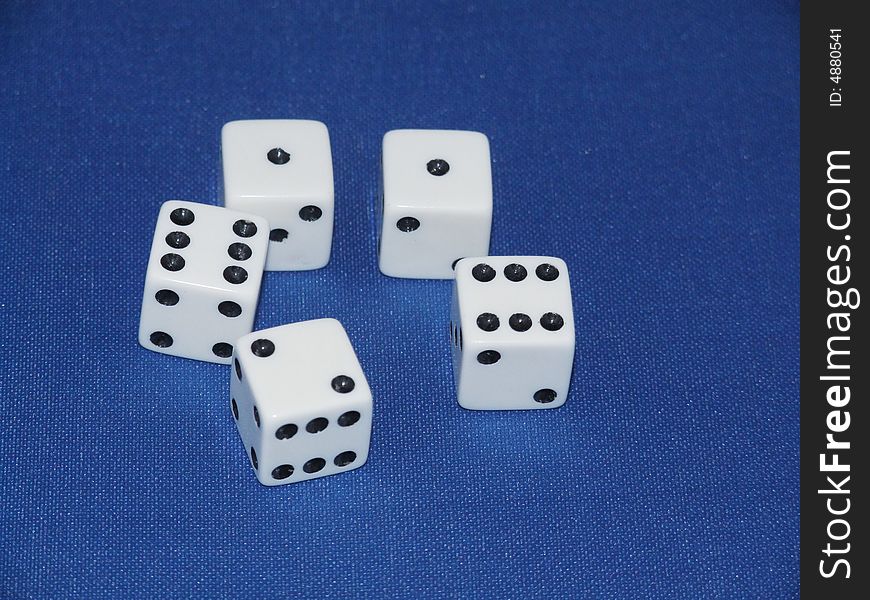 Five dice on a blue baize background