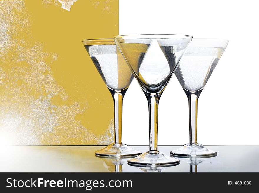 Three glasses for martini with yellow reflection