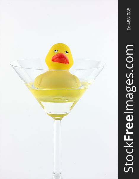 A rubber duck swimming in a cocktail glass