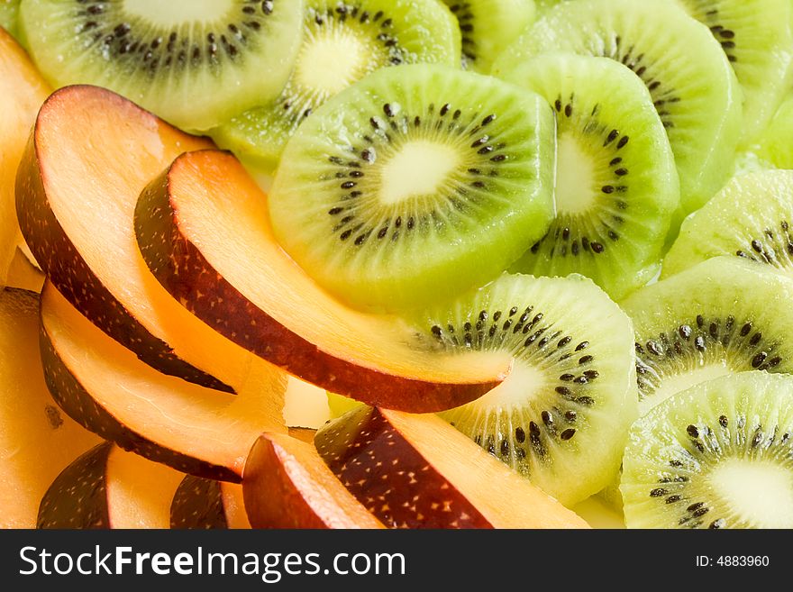 Background from sliced kiwi and plums. Background from sliced kiwi and plums.