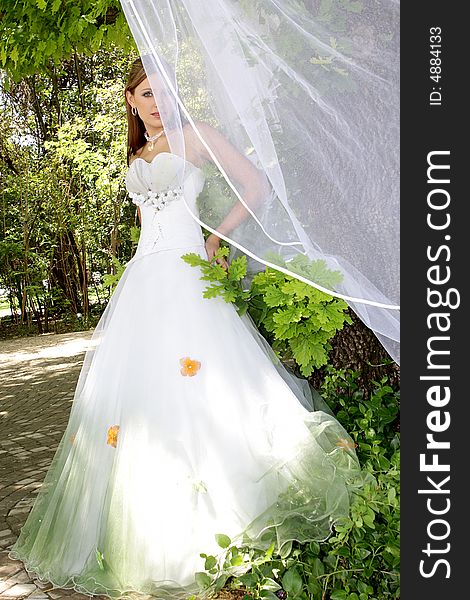 Bride standing outside in her wedding dress. Bride standing outside in her wedding dress