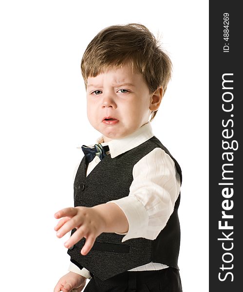 Handsome crying little boy in classic suite. Isolated on white background