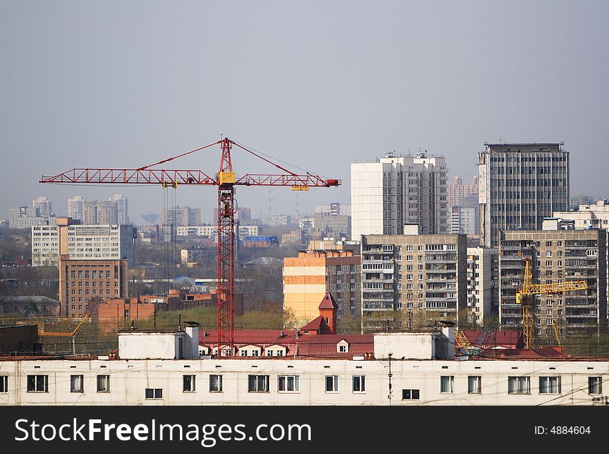 Building red crane among buildings. Building red crane among buildings