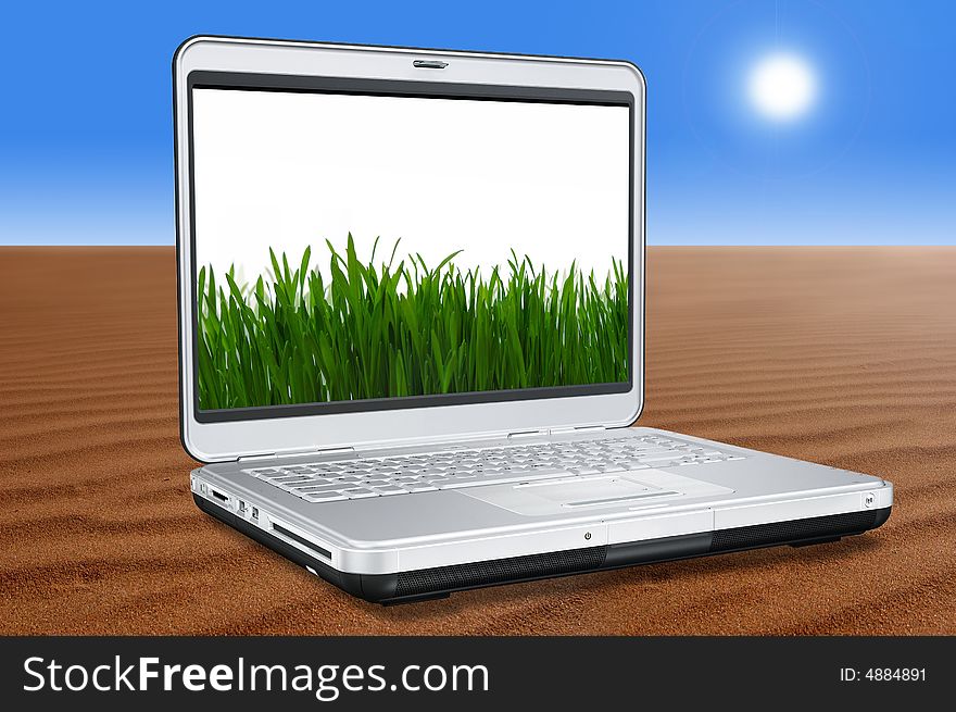 Laptop Computer with green grass on screen in the Desert