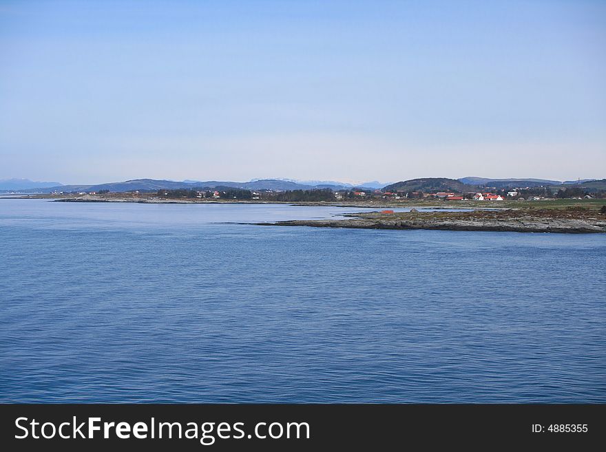 The typical norwegian coastline along a fjord taken from cruise ship between Stavanger and Haugesund.