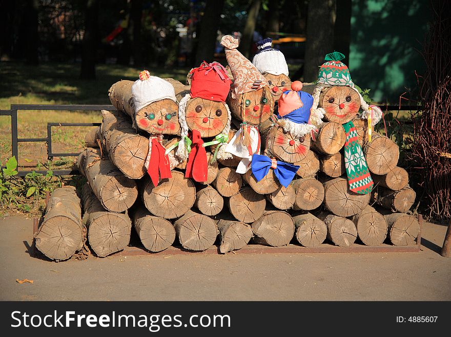 Playfully decorated fire wood combined in a woodpile. Playfully decorated fire wood combined in a woodpile