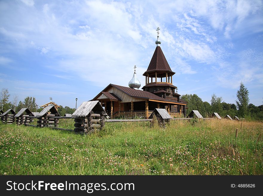 Small wooden church behind a fence