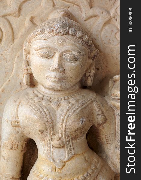 India Jaipur sculpture in an hindu temple; representation of a woman; maybe a deva; round face and voluptuous shapes