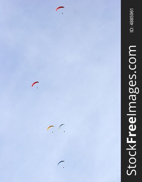 A group of paraglinders in the sky. A group of paraglinders in the sky