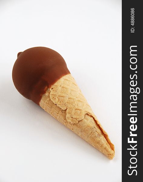 Cone of chocolate ice cream close up