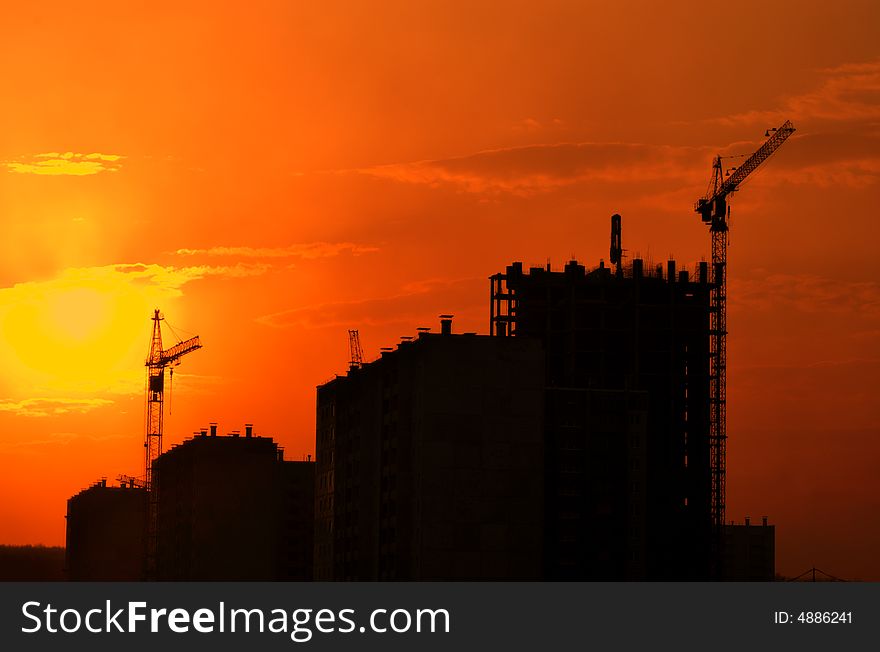 Lifting crane building the house on a construction site. Lifting crane building the house on a construction site