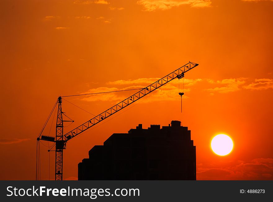 Lifting crane building the house on a construction site. Lifting crane building the house on a construction site