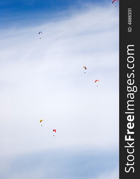 A group of paraglinders in the sky of italy. A group of paraglinders in the sky of italy