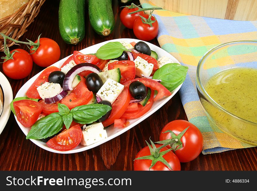 Greek salad with tomatos, mozzarella cheese, onions, olives