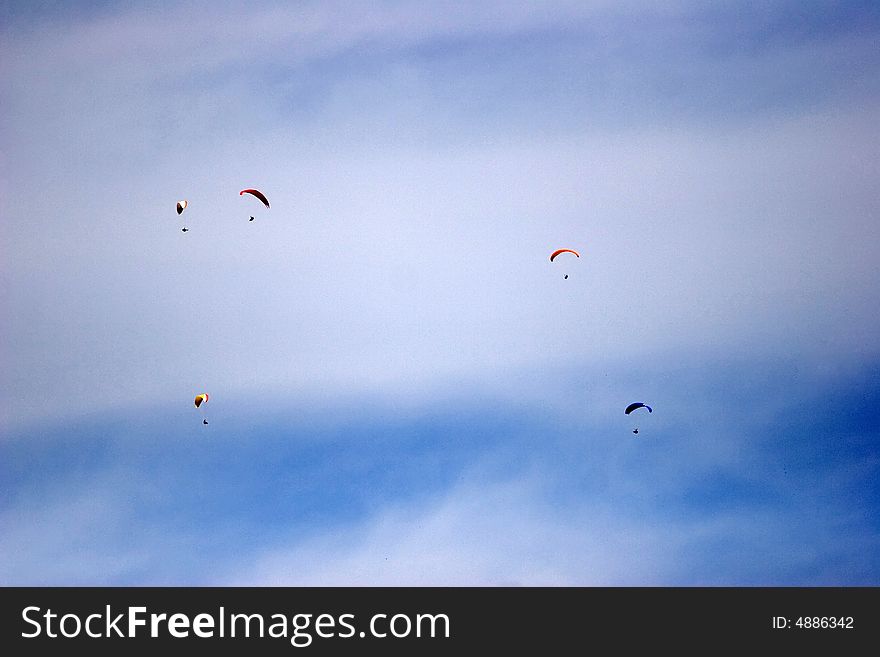 A group of paragliders in the sky of italy. A group of paragliders in the sky of italy