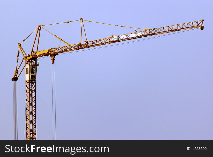 Lifting crane building the house on a construction site