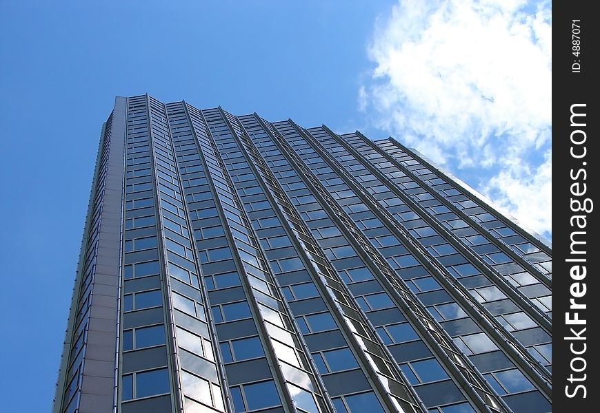 The sky is reflected in windows of a skyscraper. The sky is reflected in windows of a skyscraper