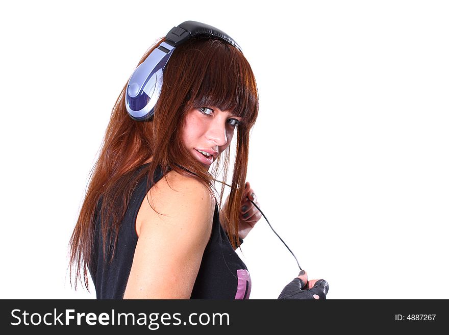 The young girl in headphones with a microphone listens to music