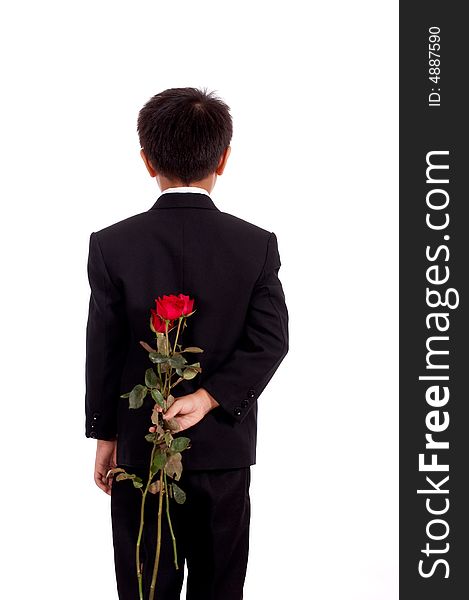 Young man in black suit holding a bunch of flower