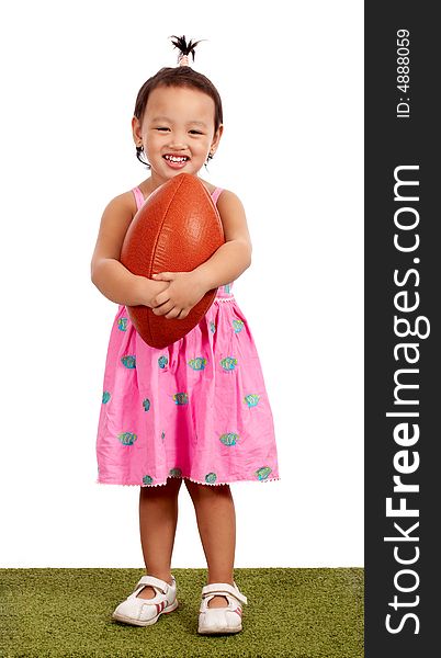 Young little girl holding a rugby ball