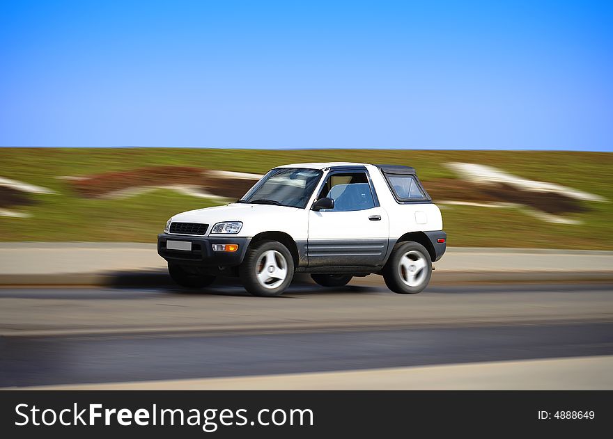 Pretty white suv in motion. Pretty white suv in motion