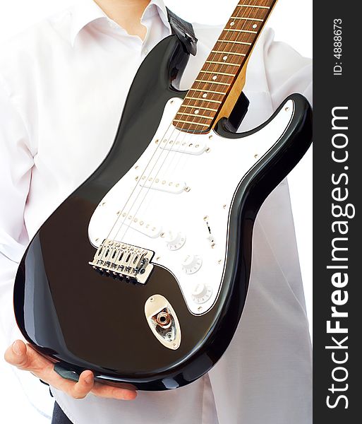 Electric guitar in hands over white