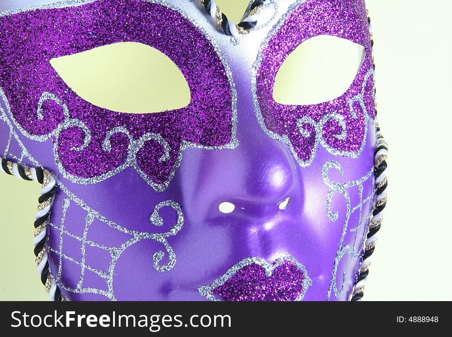 A violet mask on a yellow background