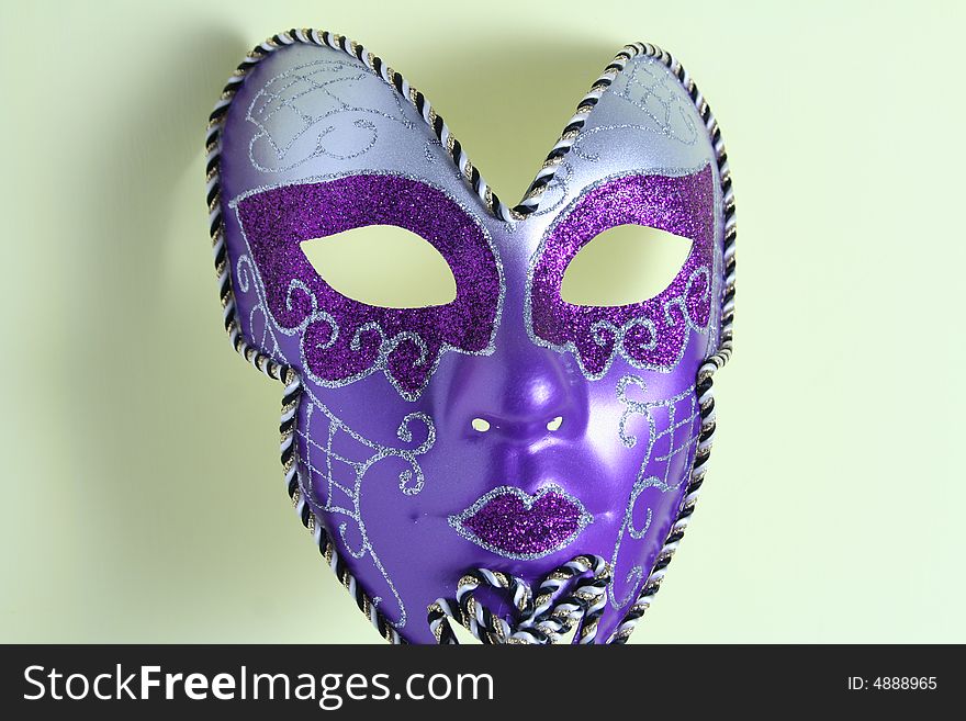 A violet mask on a yellow background