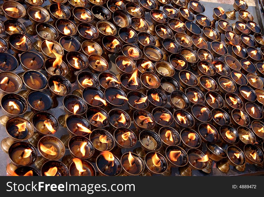 Hundred burning candles in front of Buddhist buddhatemple