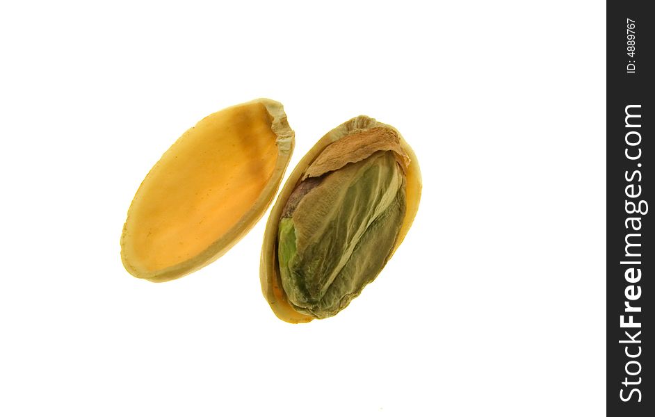 Pistachio nut with half shell removed showing green kernel