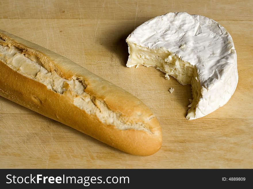 A baguette with half a camembert. A baguette with half a camembert
