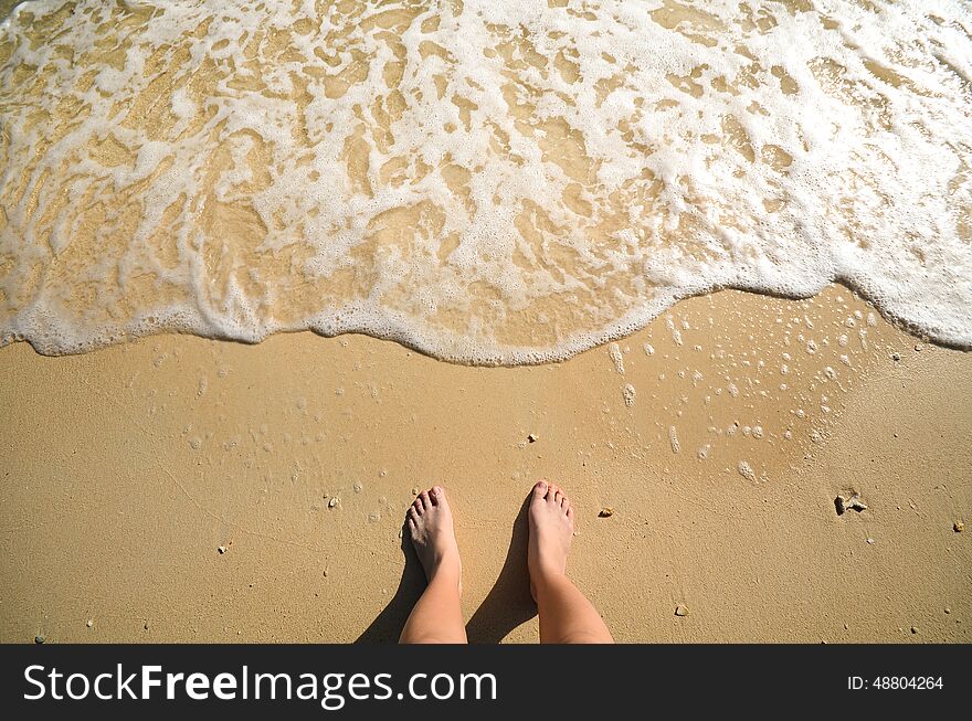 Foam and foot on sand