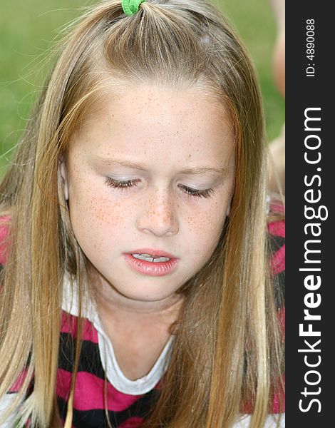 A white caucaisan girl child with an angry expression on her face. A white caucaisan girl child with an angry expression on her face