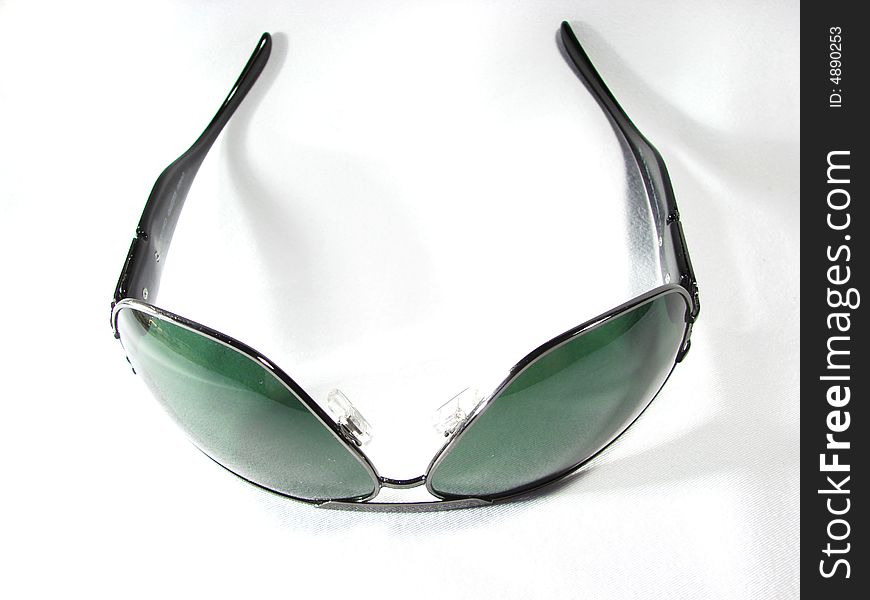 Sunglasses with dark green lenses closeup isolated. Sunglasses with dark green lenses closeup isolated