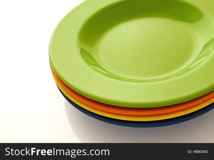 Four color ceramics plates on the white background. Four color ceramics plates on the white background