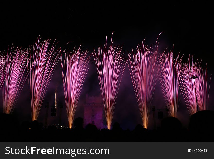 Colored fireworks in the night in lisbon near tower belem, portugal