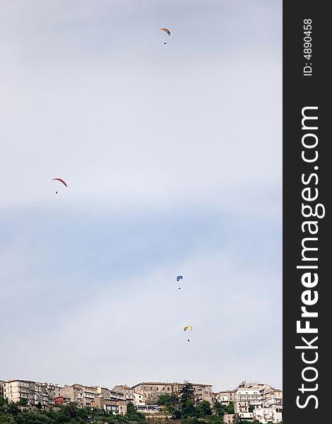 A group of the paragliders up in the sky while having fun. A group of the paragliders up in the sky while having fun