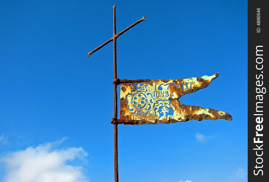 A Renaissance flag and cross atop a Tuscan castle and fortress. A Renaissance flag and cross atop a Tuscan castle and fortress.