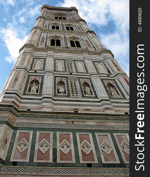 A view from the street level looking directly up the bell tower next to the Florence, Italy Duomo. The campanile (tower) was designed by the architect Giotto. A view from the street level looking directly up the bell tower next to the Florence, Italy Duomo. The campanile (tower) was designed by the architect Giotto.