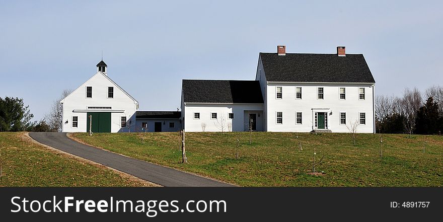 White farmhouse and barn in a rural area