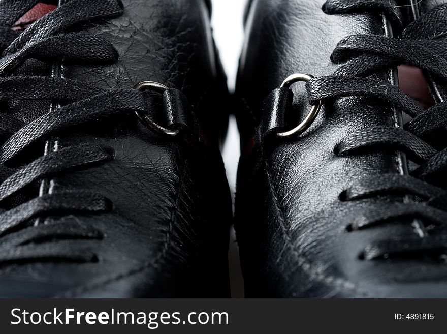 Fragment of two closeup black leather new sining shoes. Fragment of two closeup black leather new sining shoes